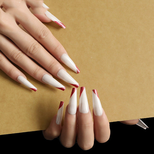 Trilumity Coffin press-on nails in Gold, worn on the hand